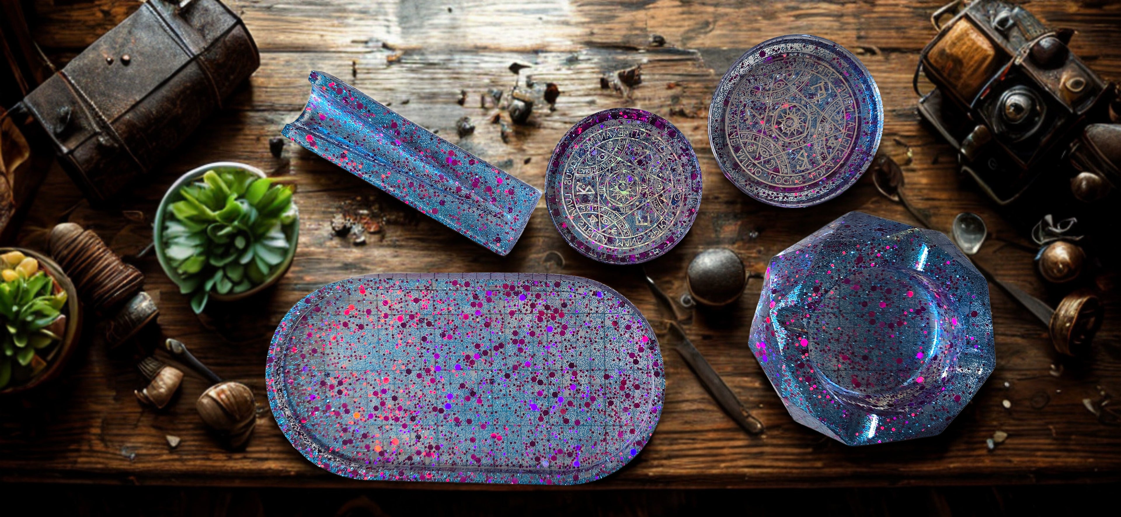 Set of colorful resin rolling trays on a wooden surface with decorative elements.