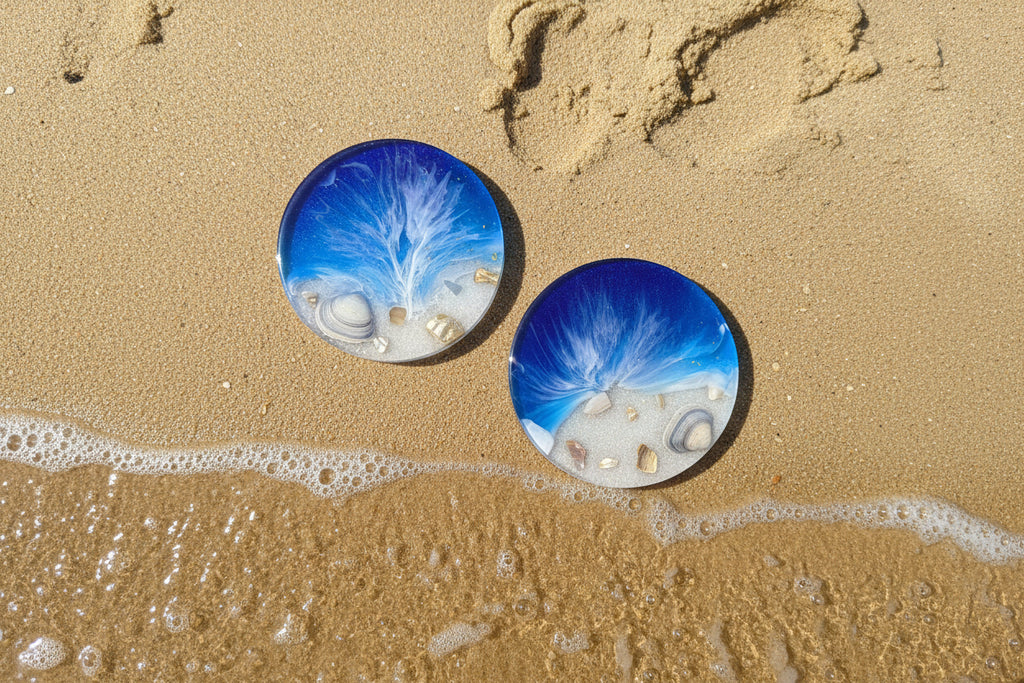 Two ocean blue resin coasters  with artistic designs 