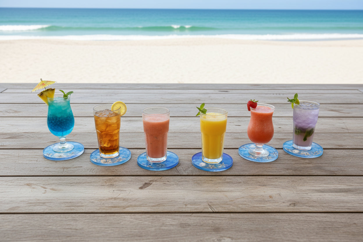 Colorful drinks on a oceanic coaster placed on picnic table next to the ocean 